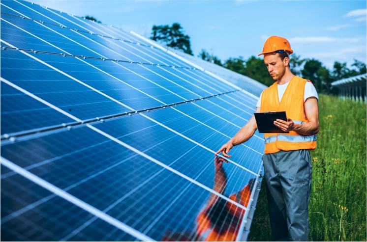 A man looking at solar panels